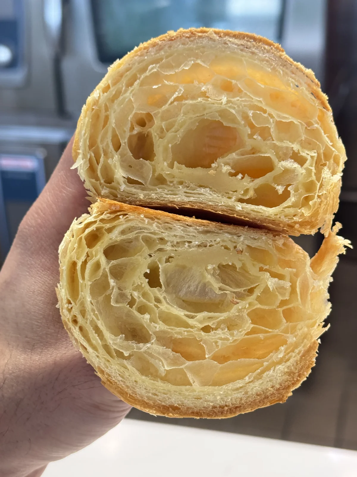 Croissant cross-section showing airy honeycomb layers — The Cake Pantry, Fishers